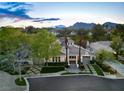 Beautiful aerial view showcasing the home's well-manicured grounds and its position against a backdrop of picturesque mountains at 1309 Reisling Ct, Las Vegas, NV 89144