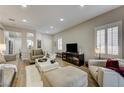 Bright living room with hardwood floors, recessed lighting, plantation shutters and contemporary furniture at 1372 Couperin Dr, Henderson, NV 89052