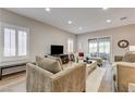 Cozy living room featuring neutral tones, hardwood floors, recessed lighting and a sliding glass door at 1372 Couperin Dr, Henderson, NV 89052