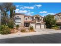 Charming home with a three-car garage, tiled roof, and front yard with manicured landscaping at 1392 Via Merano St, Henderson, NV 89052