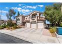 Inviting home featuring a three-car garage, well maintained landscaping, and a tiled roof at 1392 Via Merano St, Henderson, NV 89052