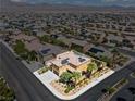 Aerial view of a two-story home with solar panels, a three-car garage, and desert landscaping at 1776 Gentle Brook St, North Las Vegas, NV 89084