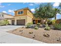 Two-story home with a three-car garage and desert landscaping including rocks and cacti at 1776 Gentle Brook St, North Las Vegas, NV 89084