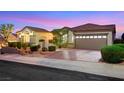 Desirable single-story residence featuring a manicured lawn, elegant landscaping, and a peaceful neighborhood atmosphere at 1960 Oliver Springs St, Henderson, NV 89052