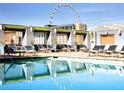 Relaxing pool area with lounge chairs and views of the city skyline at 211 E Flamingo Rd # 1012, Las Vegas, NV 89169