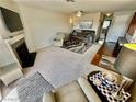 Open living room featuring a fireplace, ceiling fan, and neutral carpet at 2232 Aspen Mirror Dr # 203, Laughlin, NV 89029