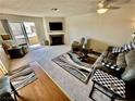 Bright living room with fireplace, sliding glass doors to balcony, and comfortable seating at 2232 Aspen Mirror Dr # 203, Laughlin, NV 89029