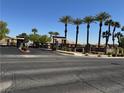 View of the Avalon community entrance with palm trees and desert landscaping on a clear day at 2900 Sunridge Heights Pkwy # 816, Henderson, NV 89052