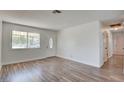 Bright and airy living room featuring new wood-look flooring, fresh paint, and an abundance of natural light at 304 Elliott Ave, Las Vegas, NV 89106