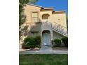 Exterior view of a two-story residence with staircase and well-manicured lawn at 3400 Cabana Dr # 1061, Las Vegas, NV 89122
