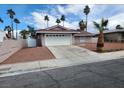 Single-story home featuring a two-car garage, low-maintenance desert landscaping, and a well-maintained exterior at 4128 Annie Oakley Dr, Las Vegas, NV 89121