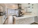Renovated kitchen with stainless steel appliances and breakfast bar at 4347 S Mojave Rd, Las Vegas, NV 89121