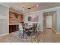 Elegant dining room featuring modern lighting, stylish decor, and wood-look floors at 5629 Portage Lake Ct, Las Vegas, NV 89130