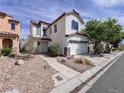 Attractive two-story home with a tiled roof, a two-car garage, and desert landscaping at 5664 Dawn Falls St, Las Vegas, NV 89148