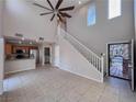 Inviting living room with high ceilings, modern ceiling fan, and staircase at 5664 Dawn Falls St, Las Vegas, NV 89148