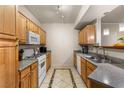 Kitchen featuring stainless appliances, granite counters, and custom tile flooring at 5855 Valley Dr # 1080, North Las Vegas, NV 89031