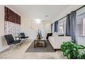 Bright living room with neutral color palette, showcasing large windows with curtains and stylish decor at 6153 Sea Cliff Cove St, North Las Vegas, NV 89031