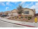 Single-story home with desert landscaping, a two car garage, and a yellow fire hydrant at 7115 Calvert Cliffs St, North Las Vegas, NV 89084