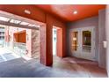 Condo entrance with red accents, gray walls, and concrete flooring at 75 E Agate Ave # 204, Las Vegas, NV 89123