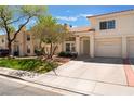 Inviting home showcasing a well-manicured lawn and a spacious driveway with brick accents at 7945 Delbonita Ave, Las Vegas, NV 89147
