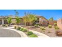 Beautiful single-story home with landscaped front yard, desert landscaping, and a two-car garage at 797 Drammatico Pl, Henderson, NV 89011
