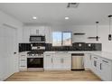 Well-designed kitchen features stainless steel appliances, black subway tile backsplash, and white cabinets at 824 N 20Th St, Las Vegas, NV 89101