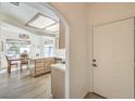 Inviting entryway with archway leading to dining area, light wood floors, and white door at 8408 Running Deer Ave # 201, Las Vegas, NV 89145