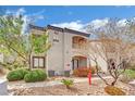 Exterior view of a two story condo with desert landscaping and access to the units at 950 Seven Hills Dr # 124, Henderson, NV 89052