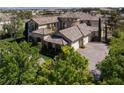 Aerial shot of a large home, boasting a circular tile roof and brick-paved driveways at 9533 Orient Express Ct, Las Vegas, NV 89145