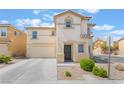 Traditional two-story home with an attached two-car garage and manicured landscaping at 9785 Iron Mine St, Las Vegas, NV 89183