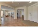 Inviting home foyer with open floor plan, wood floors, and neutral color palette at 9992 Sky Parlor Rd, Las Vegas, NV 89178