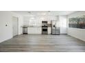 Modern kitchen with stainless steel appliances, white cabinets, granite countertops, and lots of light at 10 Yew Ave, Las Vegas, NV 89110
