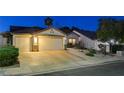 Charming single-story home featuring a three-car garage, manicured landscaping, and inviting curb appeal at 1078 Sandstone Canyon St, Henderson, NV 89012