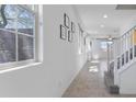Bright entryway featuring neutral tile flooring and a staircase leading to the upper level at 10925 Jordyn Hill St, Las Vegas, NV 89141