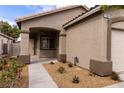 Attractive single-story home featuring a covered porch, desert landscaping, and a two-car garage at 1100 Warm Canyon Way, Las Vegas, NV 89123