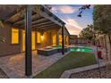 Inviting backyard with a covered patio, a built-in spa, and a pool surrounded by lush landscaping at 11274 Felice Cohn Ct, Las Vegas, NV 89179