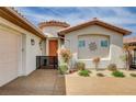 Close up of the front entry showcasing a private courtyard with a gated entrance and lush landscaping at 11342 Early Sun Ct, Las Vegas, NV 89135