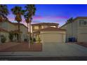 Inviting home with manicured landscaping, two car garage, and a terracotta tile roof at dusk at 1677 Balsam Mist Ave, Las Vegas, NV 89183