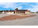 Charming single-story home featuring a red tile roof and solar panels on a desert landscape under a bright blue sky at 1800 Red Rock Dr, Pahrump, NV 89048