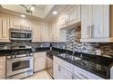 Stylish kitchen boasts stainless steel appliances and granite countertops with a tile backsplash at 220 E Flamingo Rd # 402, Las Vegas, NV 89169