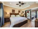 Cozy main bedroom with a large bed, wood floors, and sliding mirror door closet at 220 E Flamingo Rd # 402, Las Vegas, NV 89169