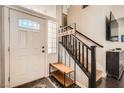 Bright entryway features decorative door glass, hardwood flooring, and a staircase at 2288 Red Alder St, Henderson, NV 89002