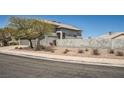 This home features a well-maintained exterior, complete with tasteful landscaping and privacy wall at 2288 Red Alder St, Henderson, NV 89002