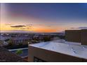 A beautiful sunset overlooking the valley with city lights and a mountain backdrop at 261 Crimson Edge St, Henderson, NV 89012