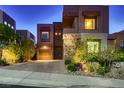 Contemporary two-story home featuring desert landscaping and a stone driveway at 261 Crimson Edge St, Henderson, NV 89012