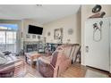 Cozy living room with a fireplace, tv, and wood floors at 3150 Soft Breezes Dr # 2018, Las Vegas, NV 89128