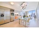 Modern kitchen with stainless steel appliances, a glass dining table, and expansive windows at 3726 Las Vegas Blvd # 2605, Las Vegas, NV 89158