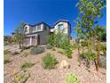 Beautiful, landscaped home with a three-car garage and well-maintained front yard at 3921 Jacob Lake Cir, Las Vegas, NV 89118