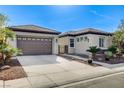 An attractive single story home featuring a two car garage, an entry gate, and desert landscaping at 4137 Cackling Goose Dr, North Las Vegas, NV 89084