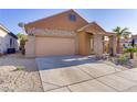 Exterior elevation featuring a two-car garage, a front porch, and desert landscaping at 437 Via Stretto Ave, Henderson, NV 89011